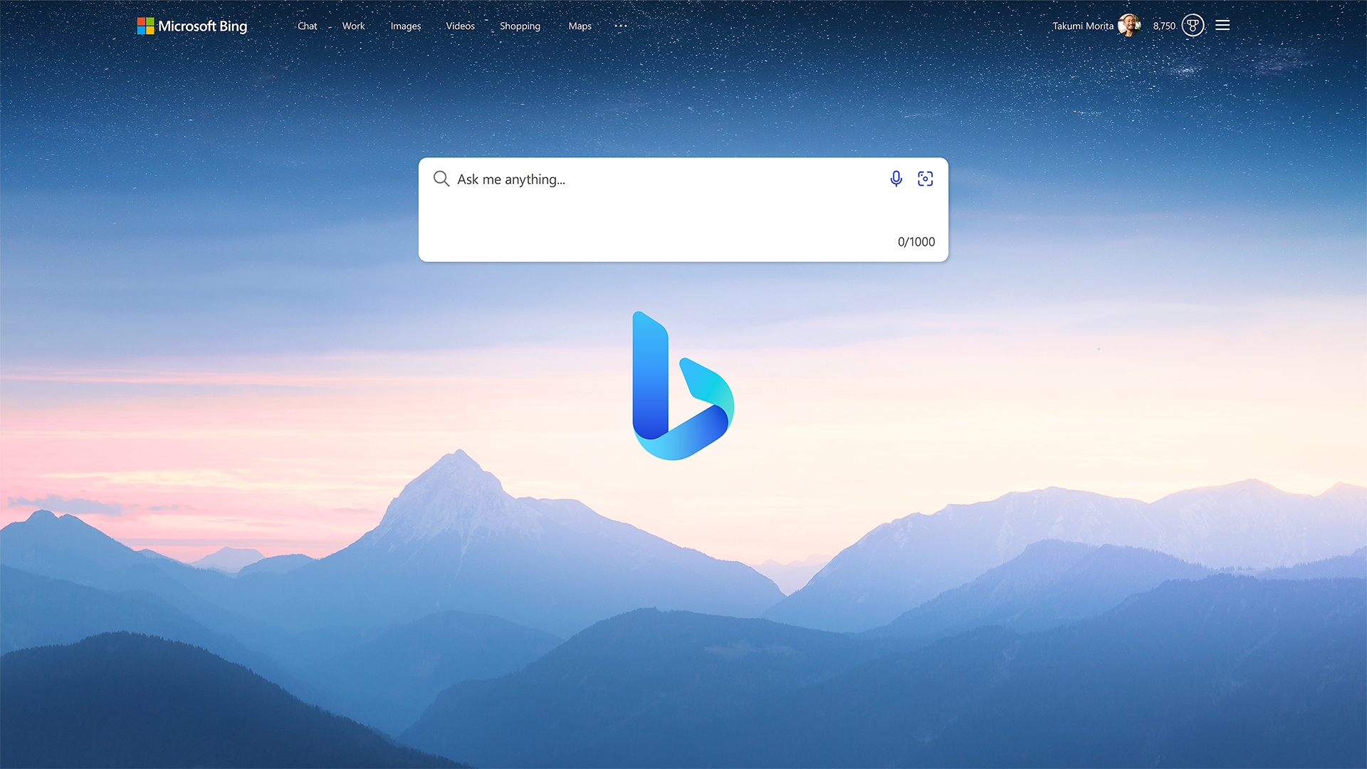 A screenshot of the redesigned Bing search interface featuring a serene mountain landscape in the background, a prominent search bar with the prompt "Ask me anything," and the Bing logo centered on the screen. The interface highlights Bing's fresh and user-friendly design, with options for Chat, Work, Images, Videos, Shopping, and Maps.